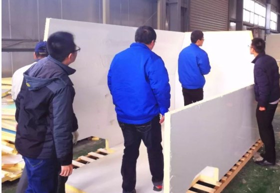 Insulated sandwich panels being fitted during assembly of a refrigerated body